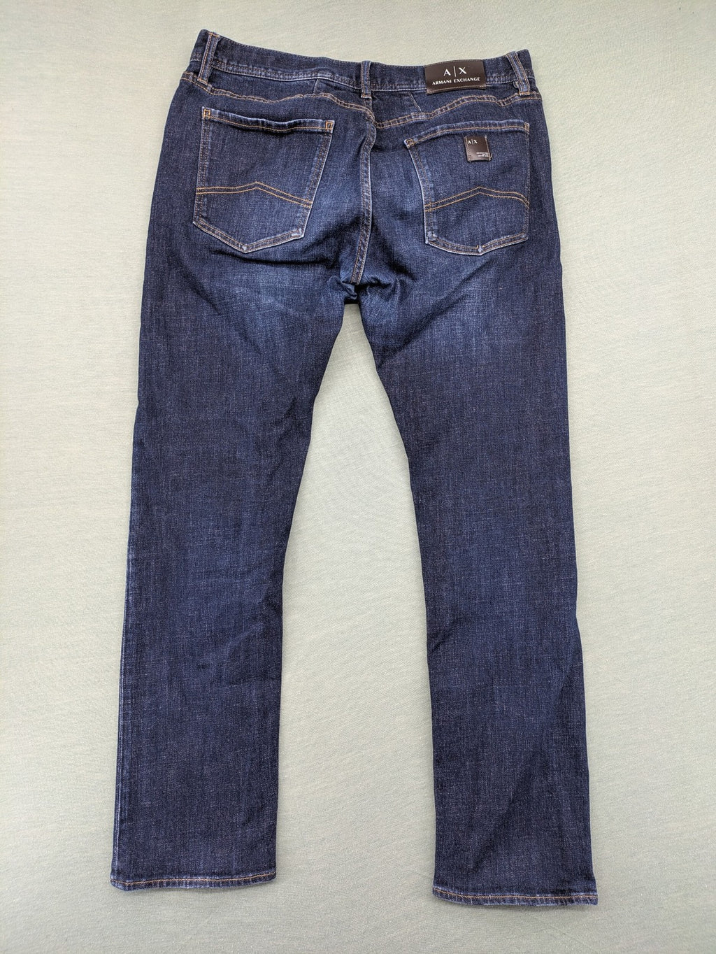 Armani Exchange blue slim fit jeans with distressed details and classic 5-pocket design.