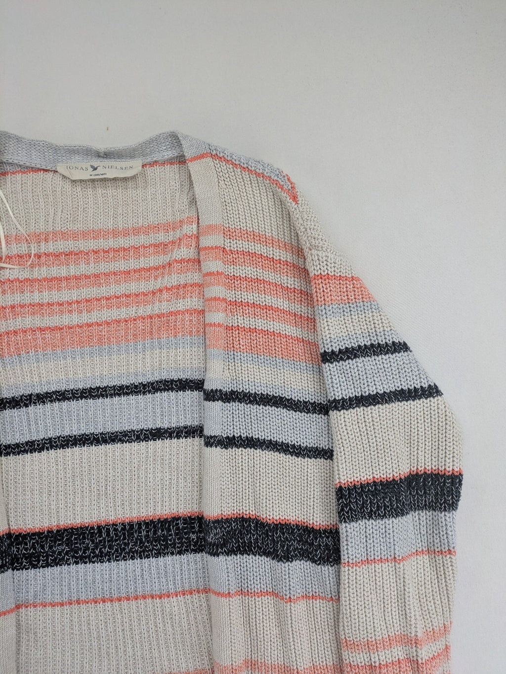 Jonas multi turtle neck jumper with striped pattern and open front design.