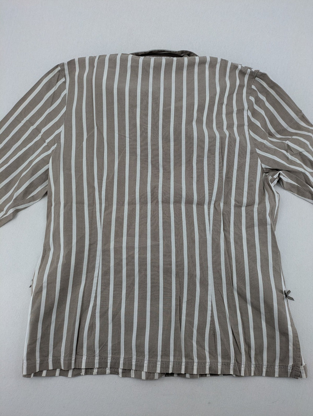 Body Sunday beige and white striped loungewear top with bow accents and button placket.