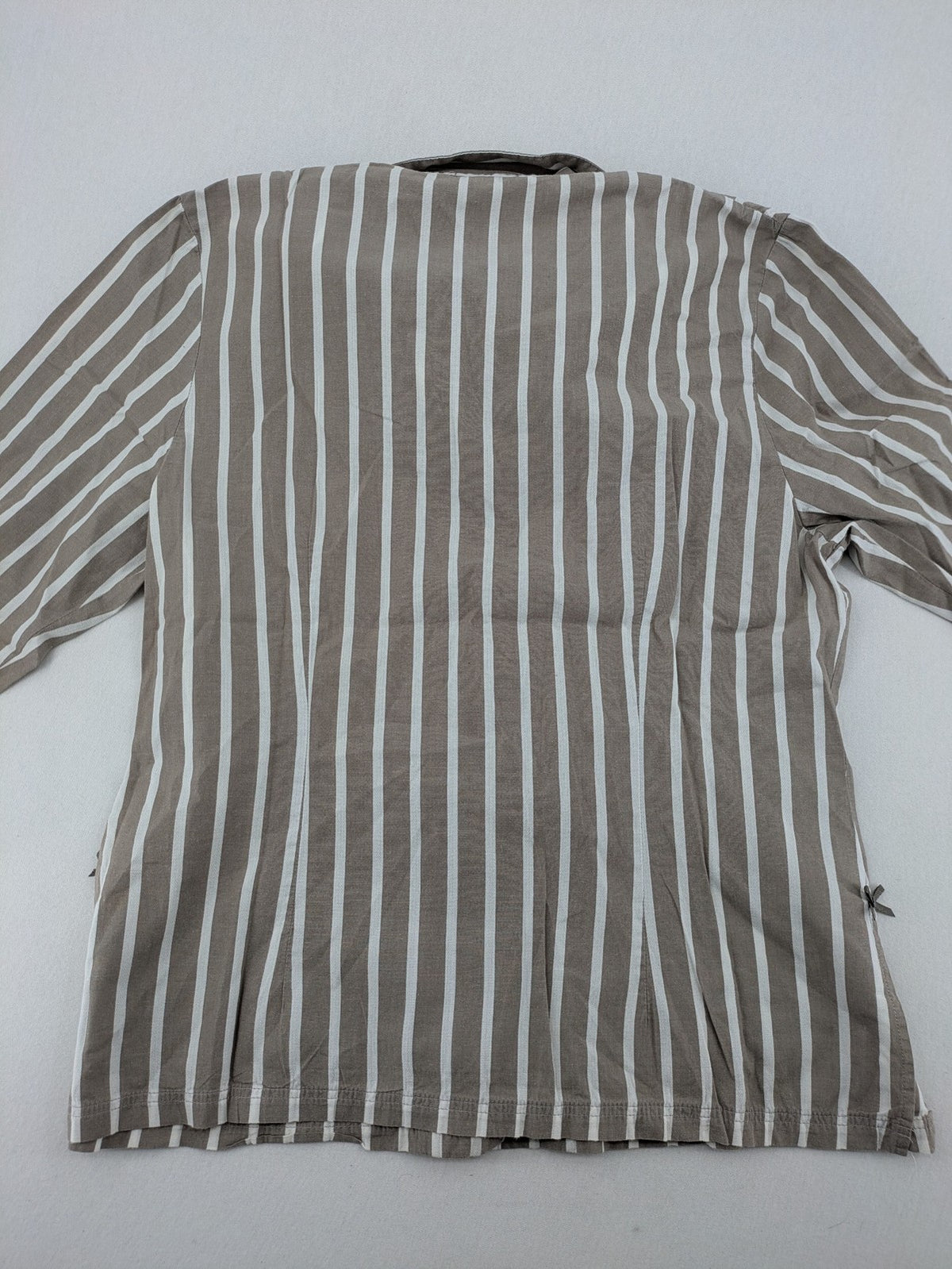 Body Sunday beige and white striped loungewear top with bow accents and button placket.