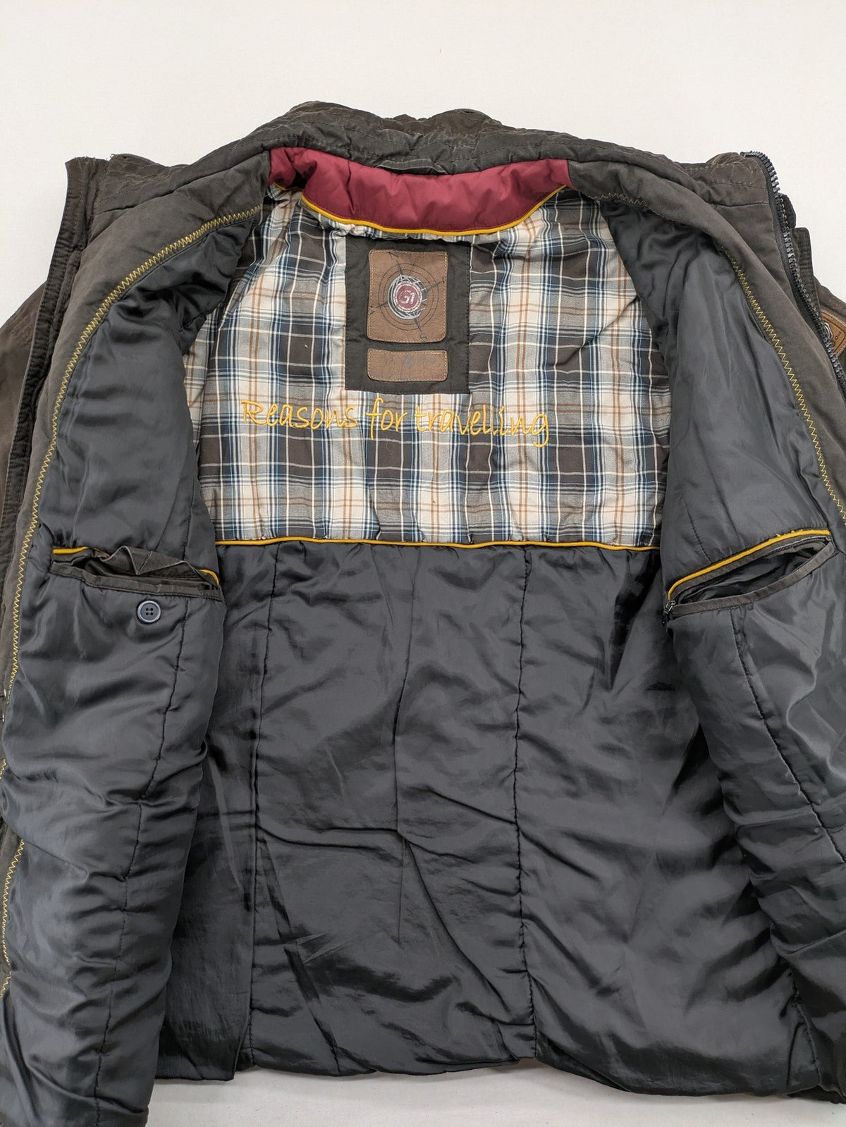 Gate One brown field jacket with plaid lining, multiple pockets, and zip-button closure.
