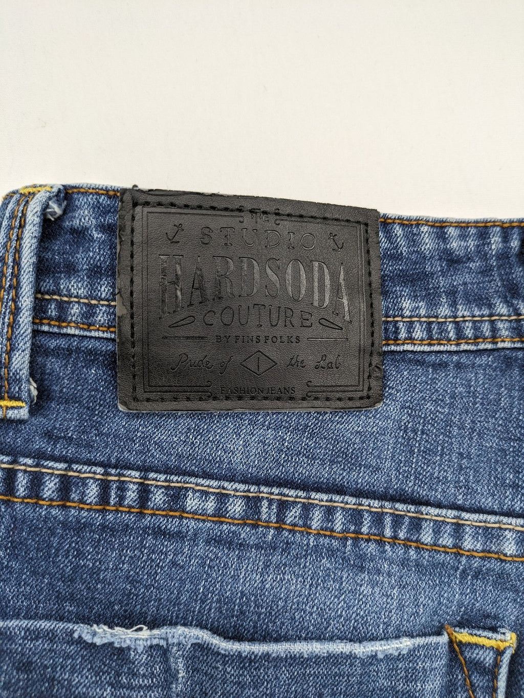 Soda blue straight jeans with distressed rips and button fly, cotton blend material.