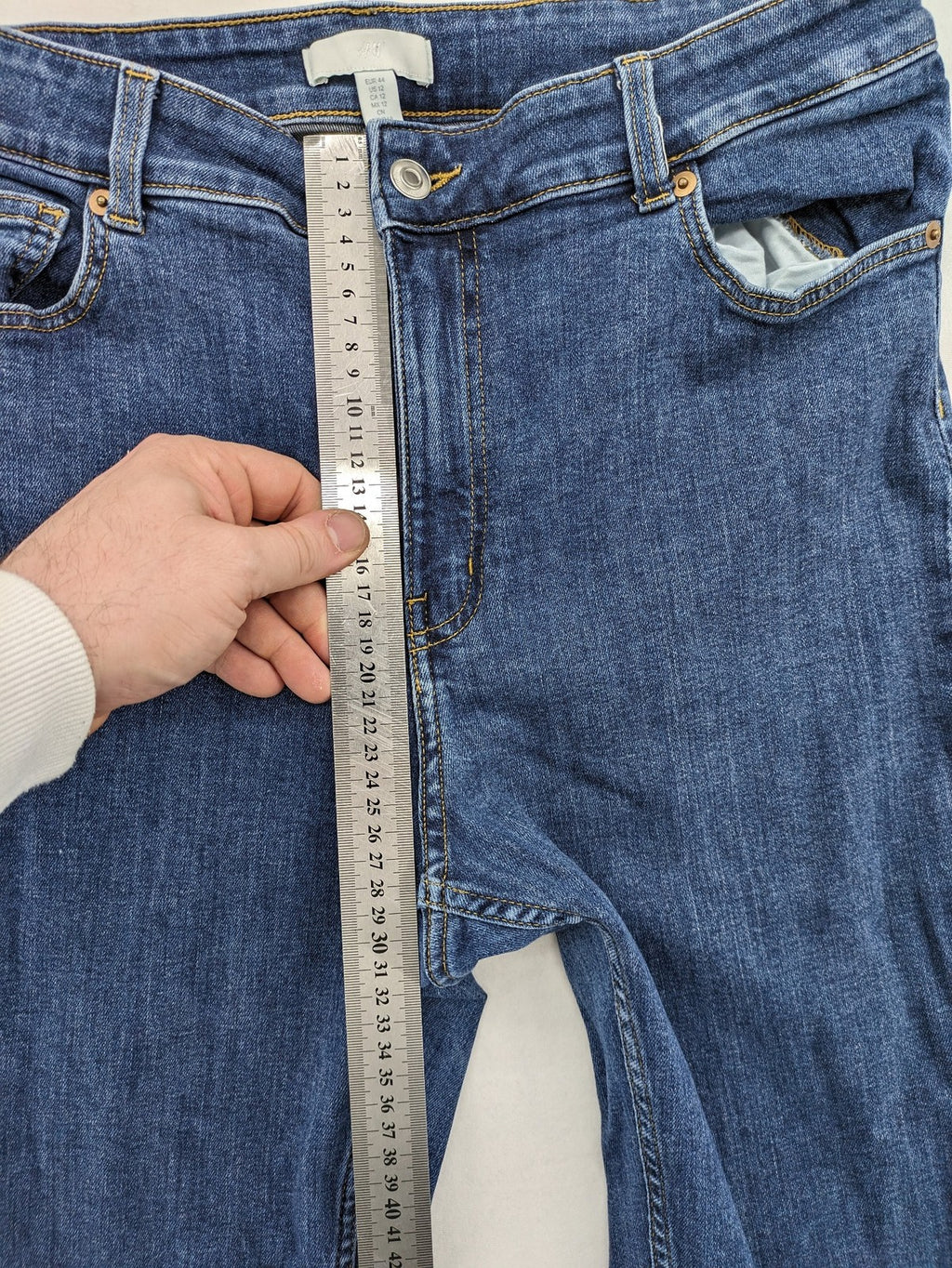 H&M blue skinny jeans with stretch denim and slim fit design.
