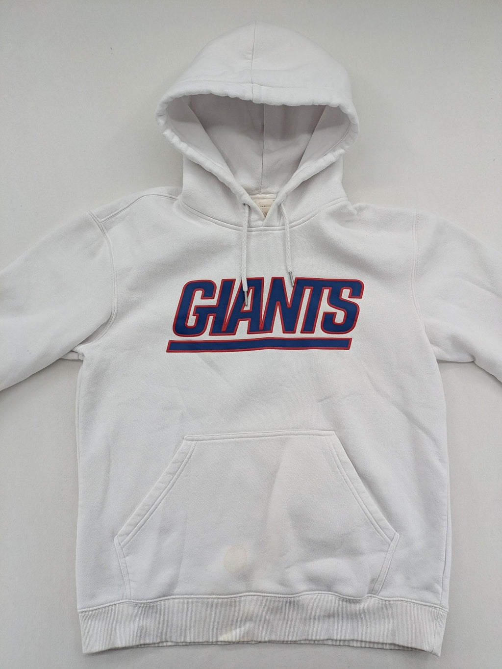 New York white hoodie with raised blue and red "GIANTS" logo and adjustable hood.