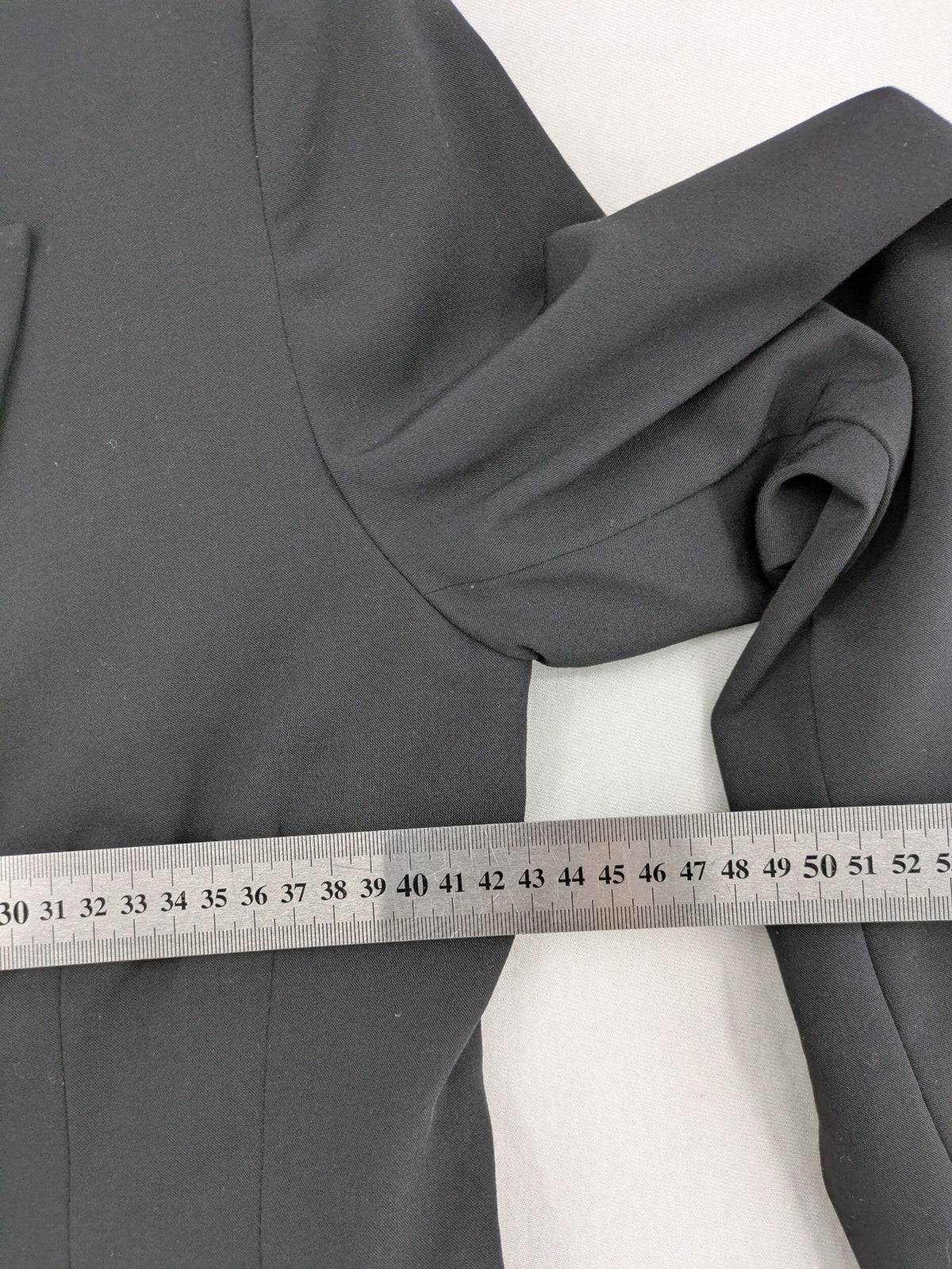 Lindex black blazer coat two-button design with subtle embroidery and tailored silhouette.