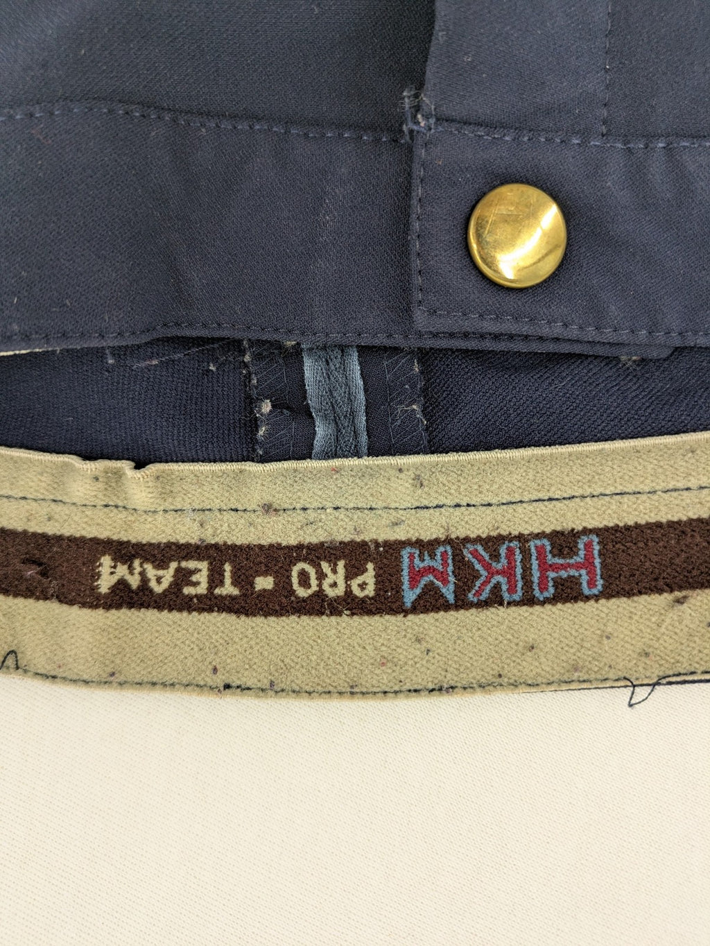 H&KM beige riding pants with dark blue full seat and front zippers.