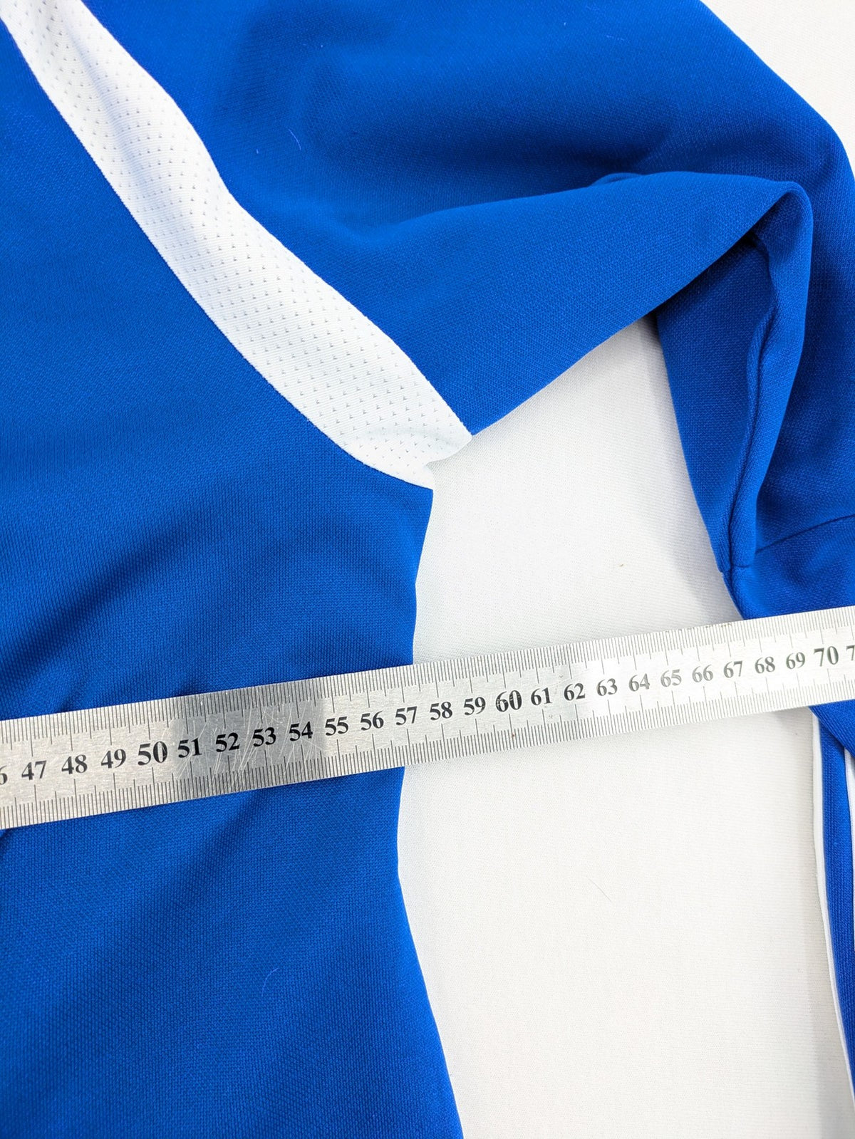 Adidas blue long sleeve top with white three stripes and 1/4 zip collar.