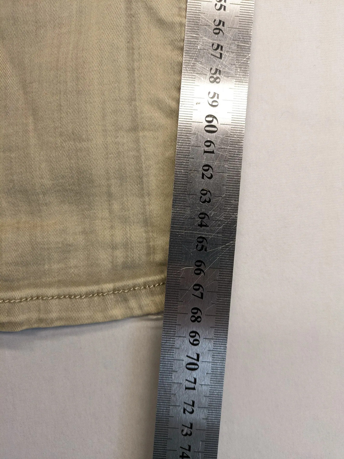 Mozaar beige straight jeans with unique asymmetrical button placket and practical pockets.