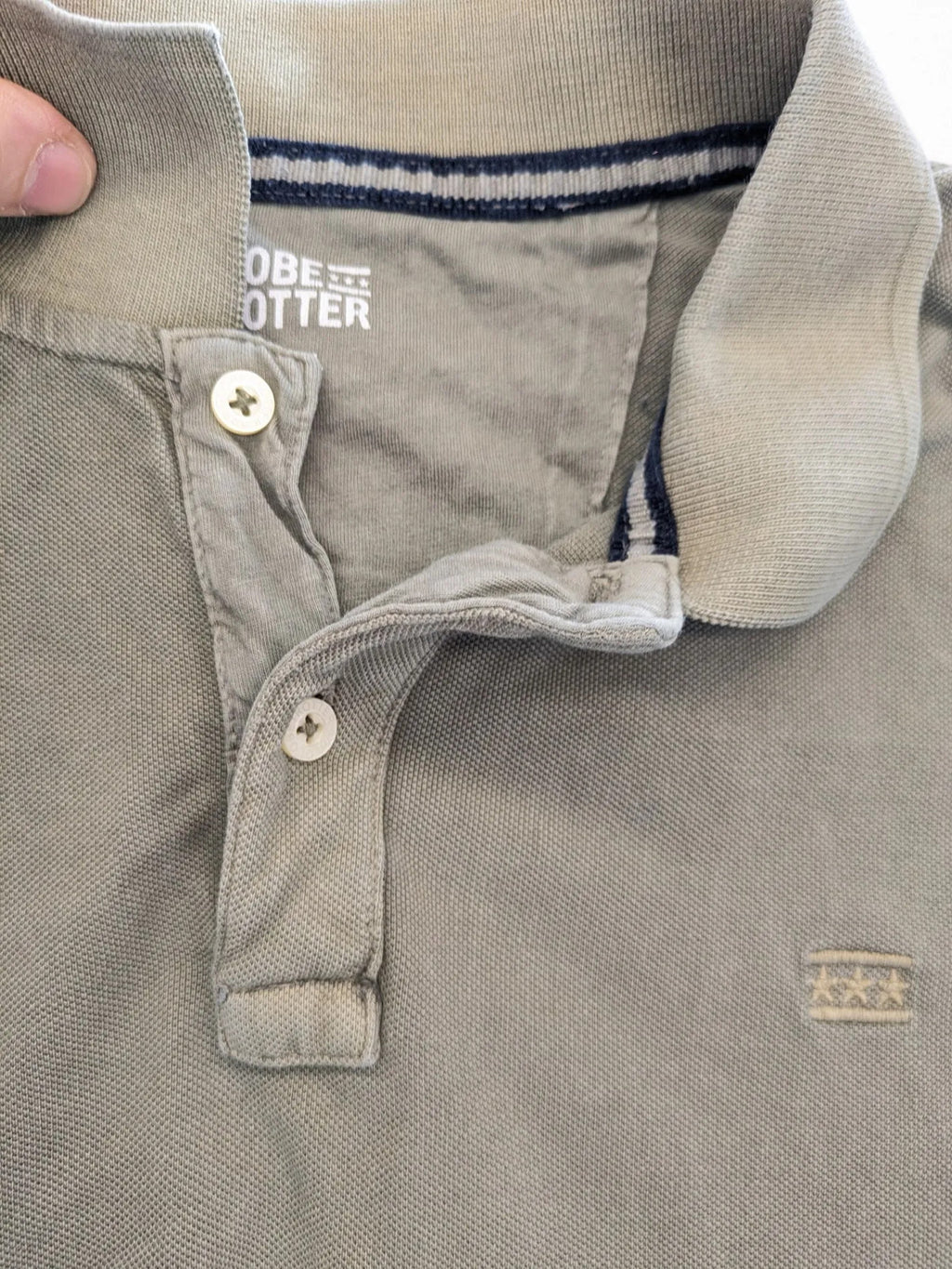 Globe-Trotter beige khaki polo shirt with classic collar and small chest logo.