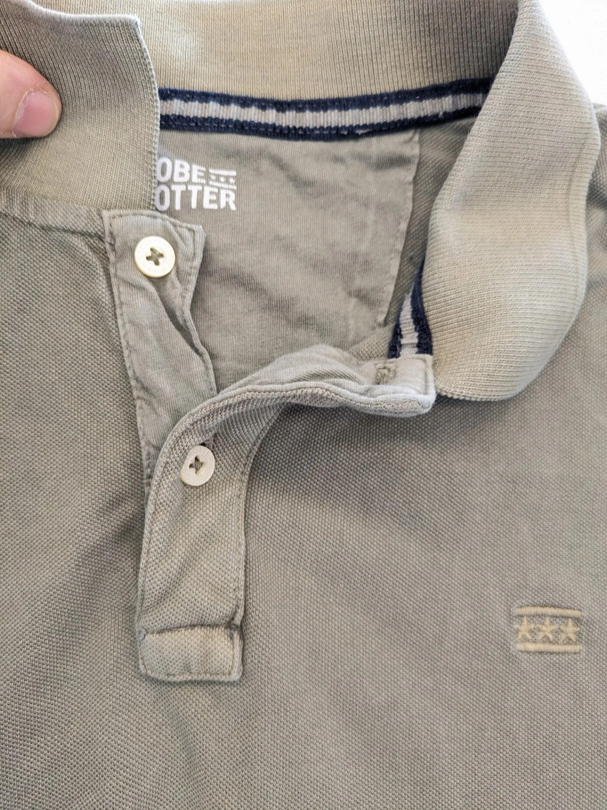 Globe-Trotter beige khaki polo shirt with classic collar and small chest logo.