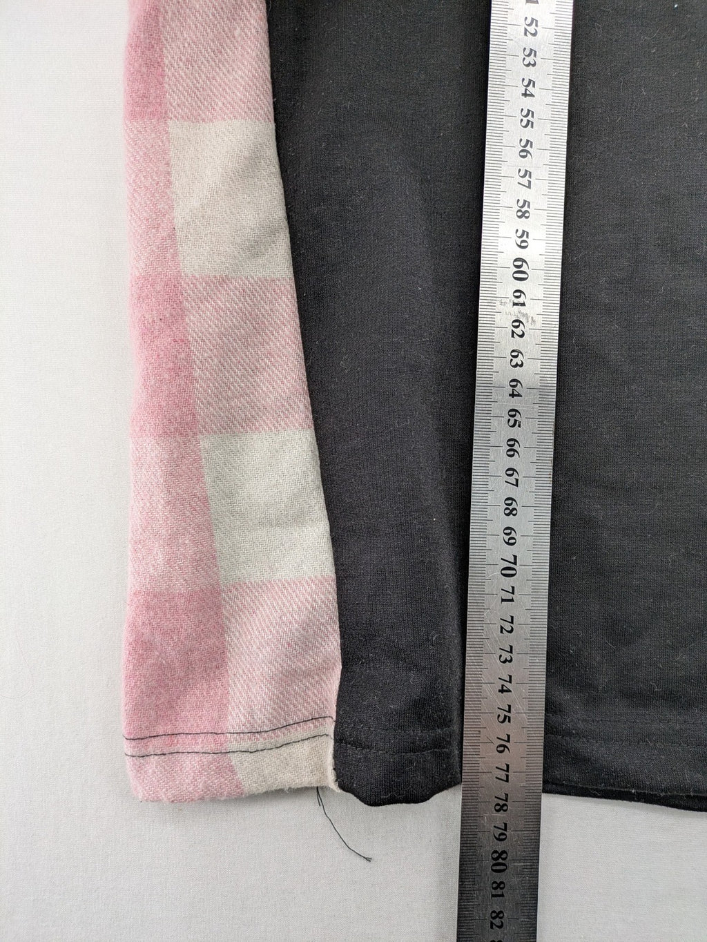 L'ange pink hoodie dress with black body and contrasting pink-white checkered panels.
