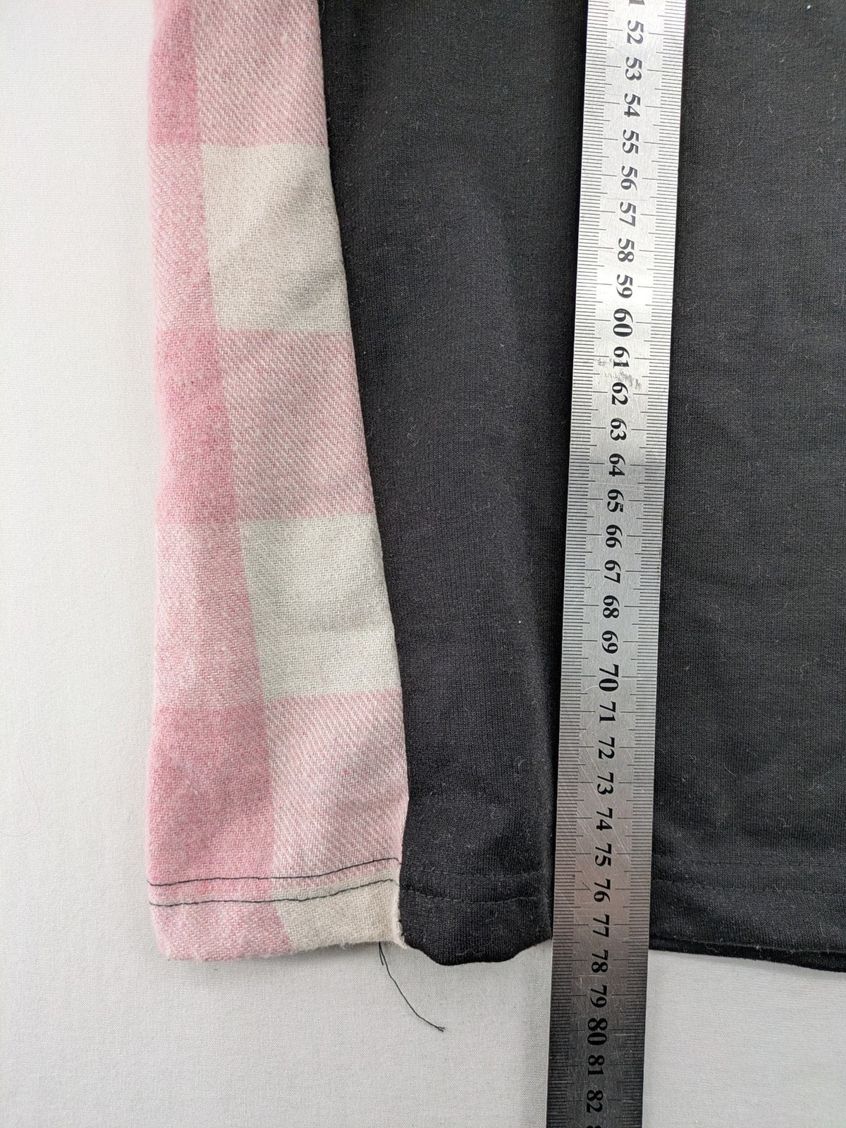 L'ange pink hoodie dress with black body and contrasting pink-white checkered panels.