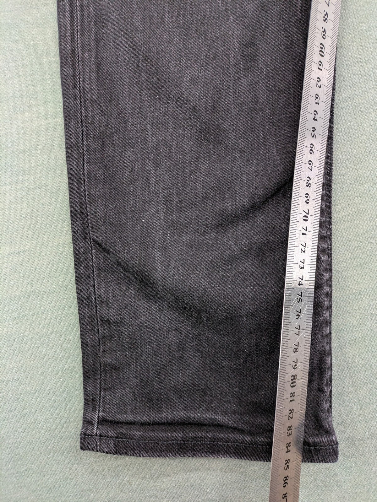Jack & Jones black slim fit jeans faded wash stretch denim with logo detail.