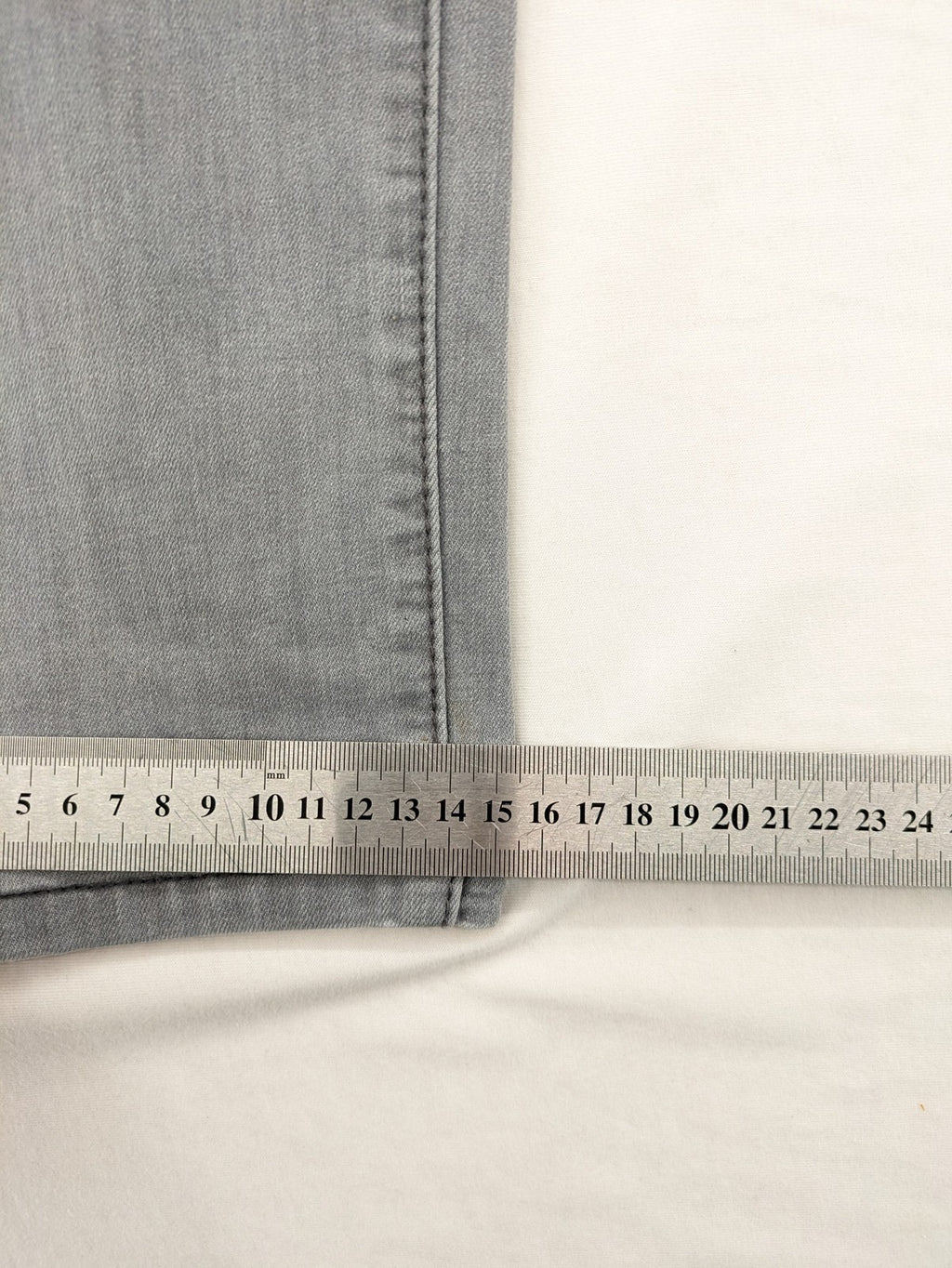 Born Rich grey slim fit jeans with logo patch and washed denim texture.