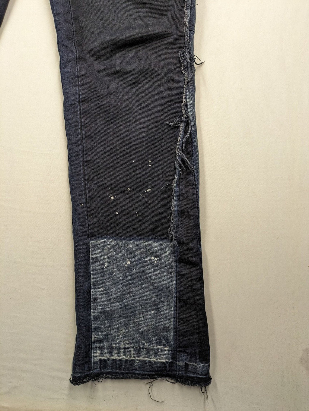 Reternity straight jeans blue black patchwork design with distressed details and frayed seams.
