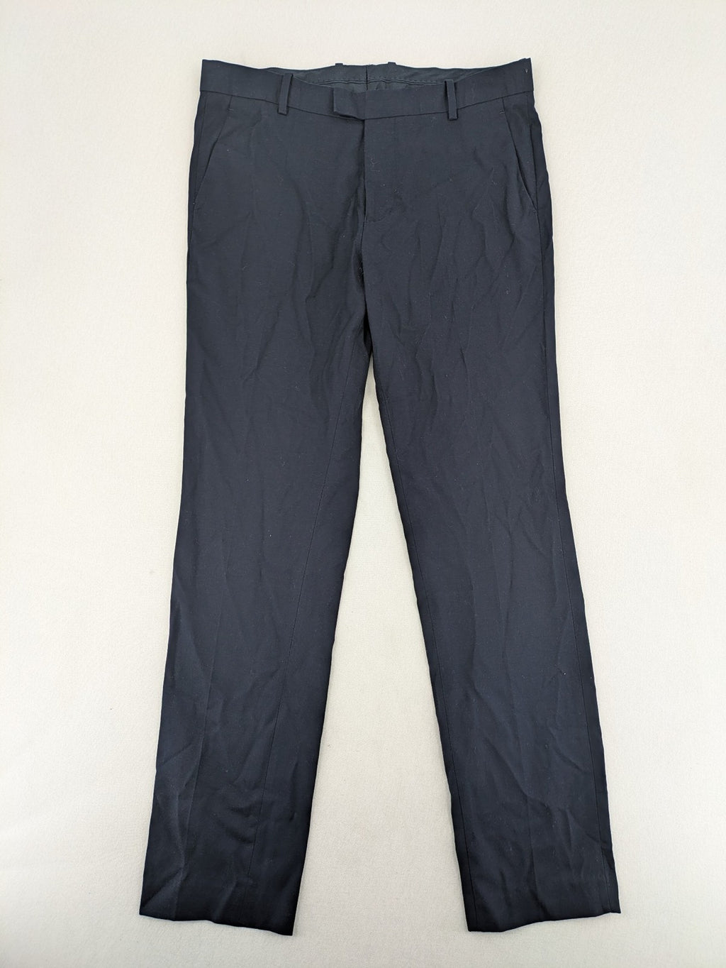 H&M navy slim fit executive suit trousers with flat-front design and side pockets.