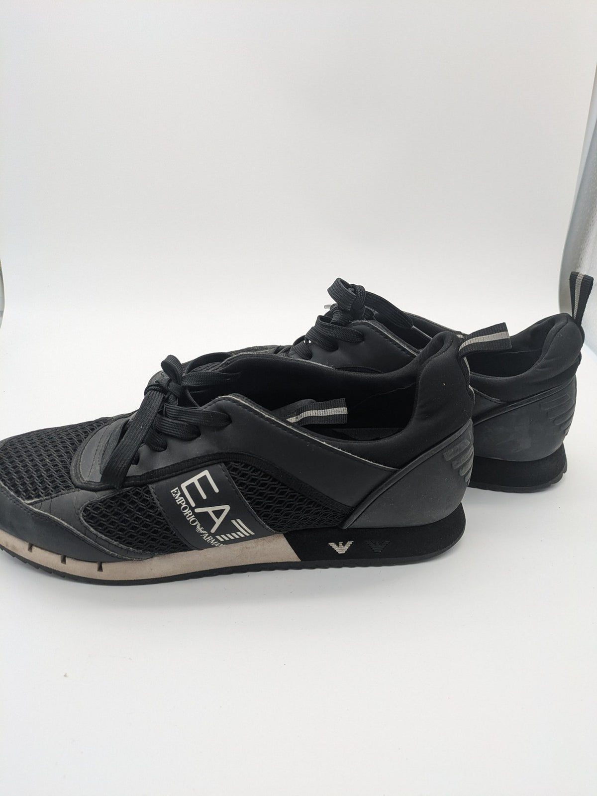 EA7 Emporio Armani beige and black sneakers with prominent EA7 branding and breathable mesh details.
