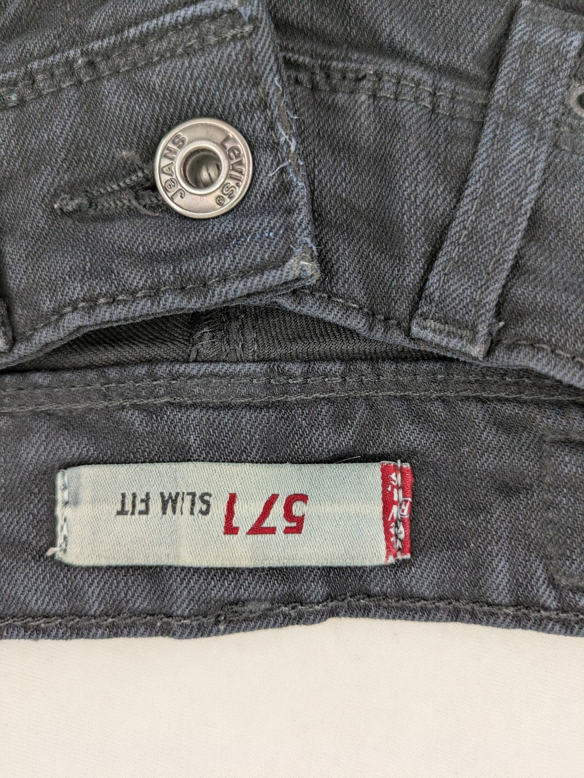 Levi's black slim fit jeans with classic 5-pocket design and zipper fly.