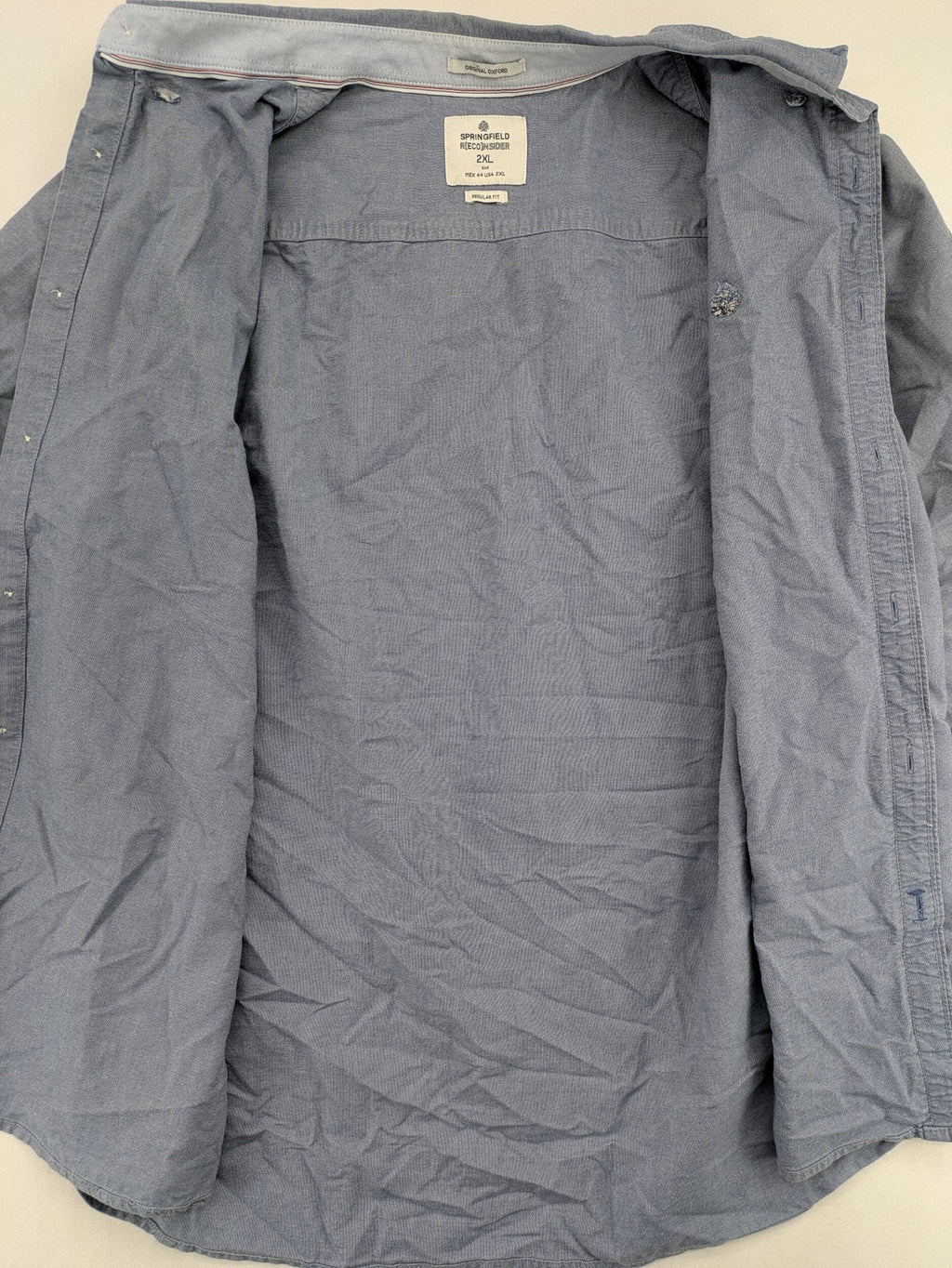 Springfield blue Oxford shirt with button placket and subtle logo embroidery.