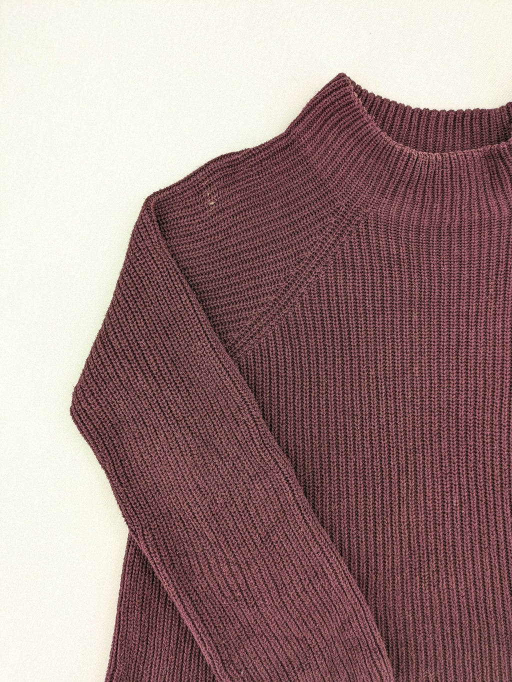 Monari burgundy knit jumper with standing collar, ribbed texture, and raglan sleeves.