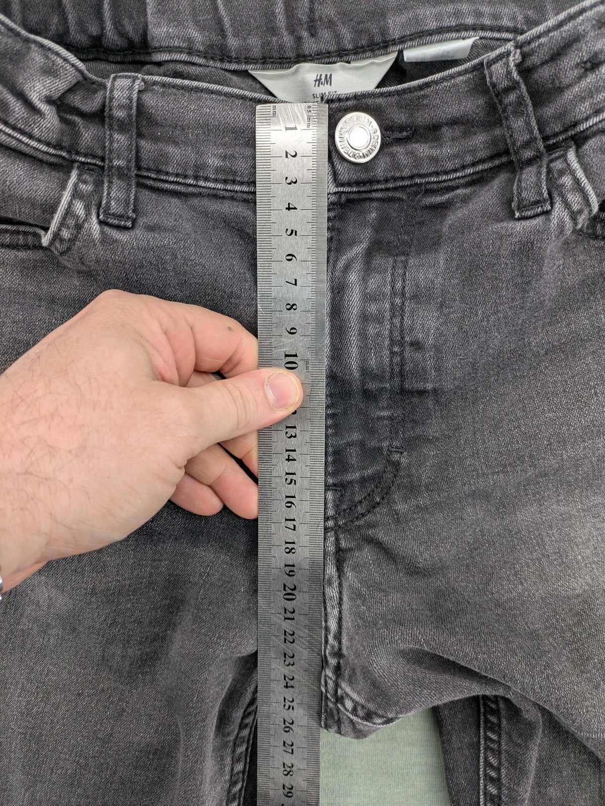 H&M grey slim fit jeans with adjustable waistband and faded wash detail.