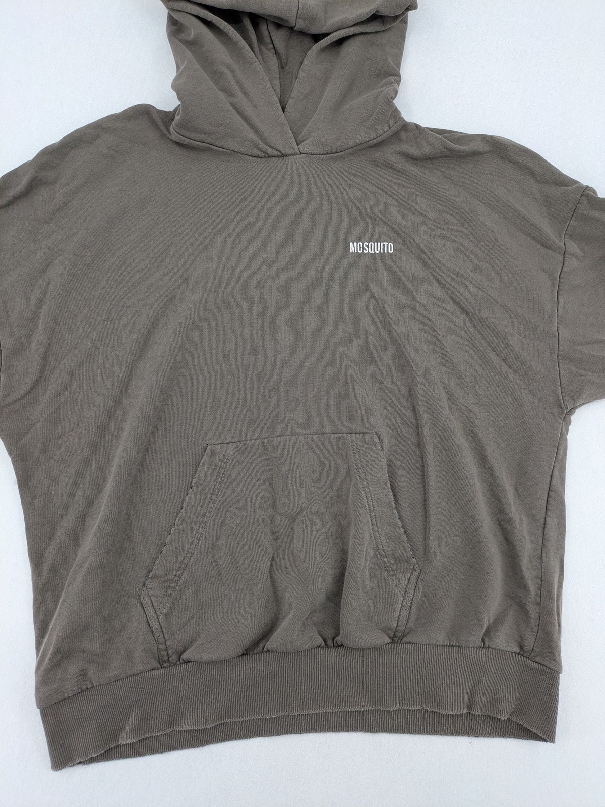 Mosquito grey hoodie with distressed cuffs and subtle logo on the chest.