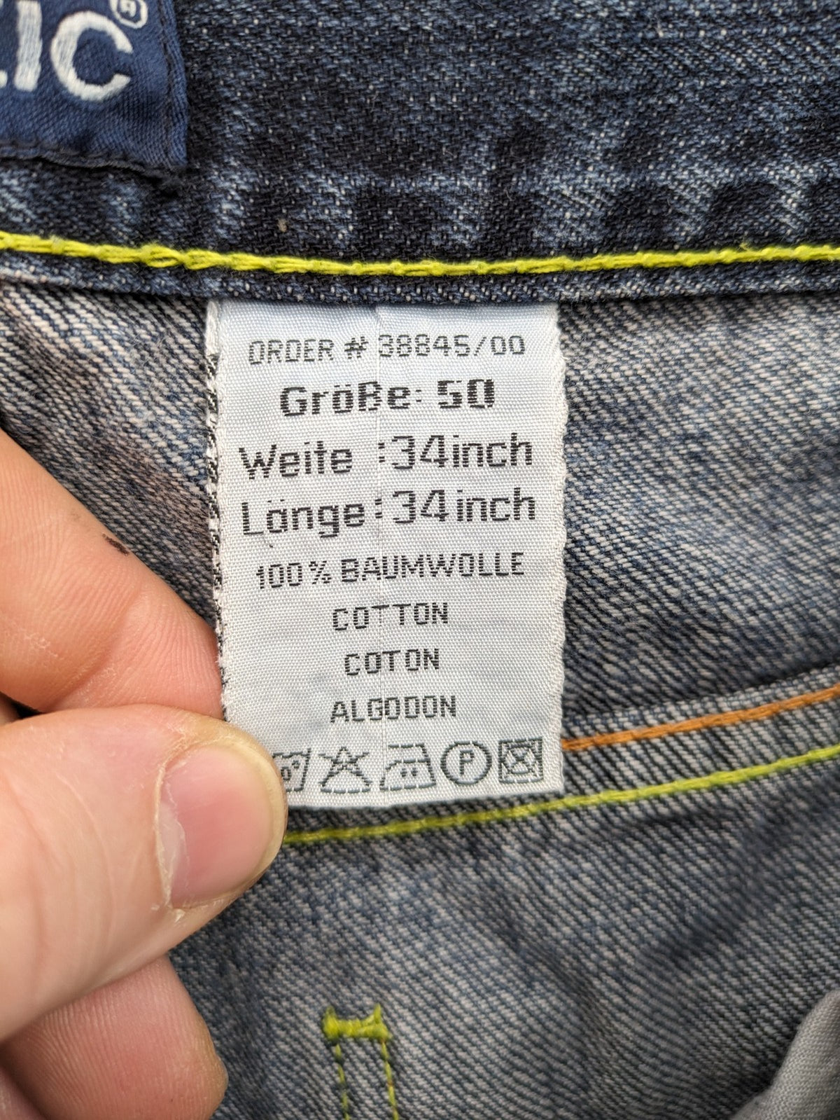 Identic orange straight jeans with paneled design and contrasting yellow stitching.