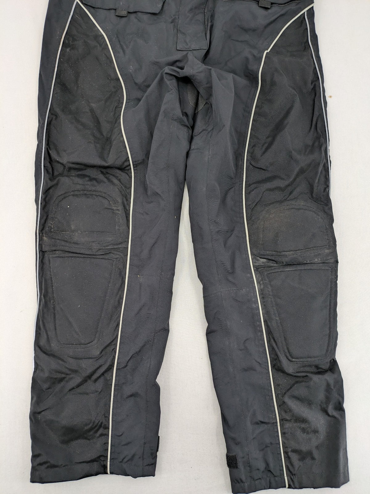 Polo black chaps with grey and white accents, featuring protective knee pads and adjustable belt.