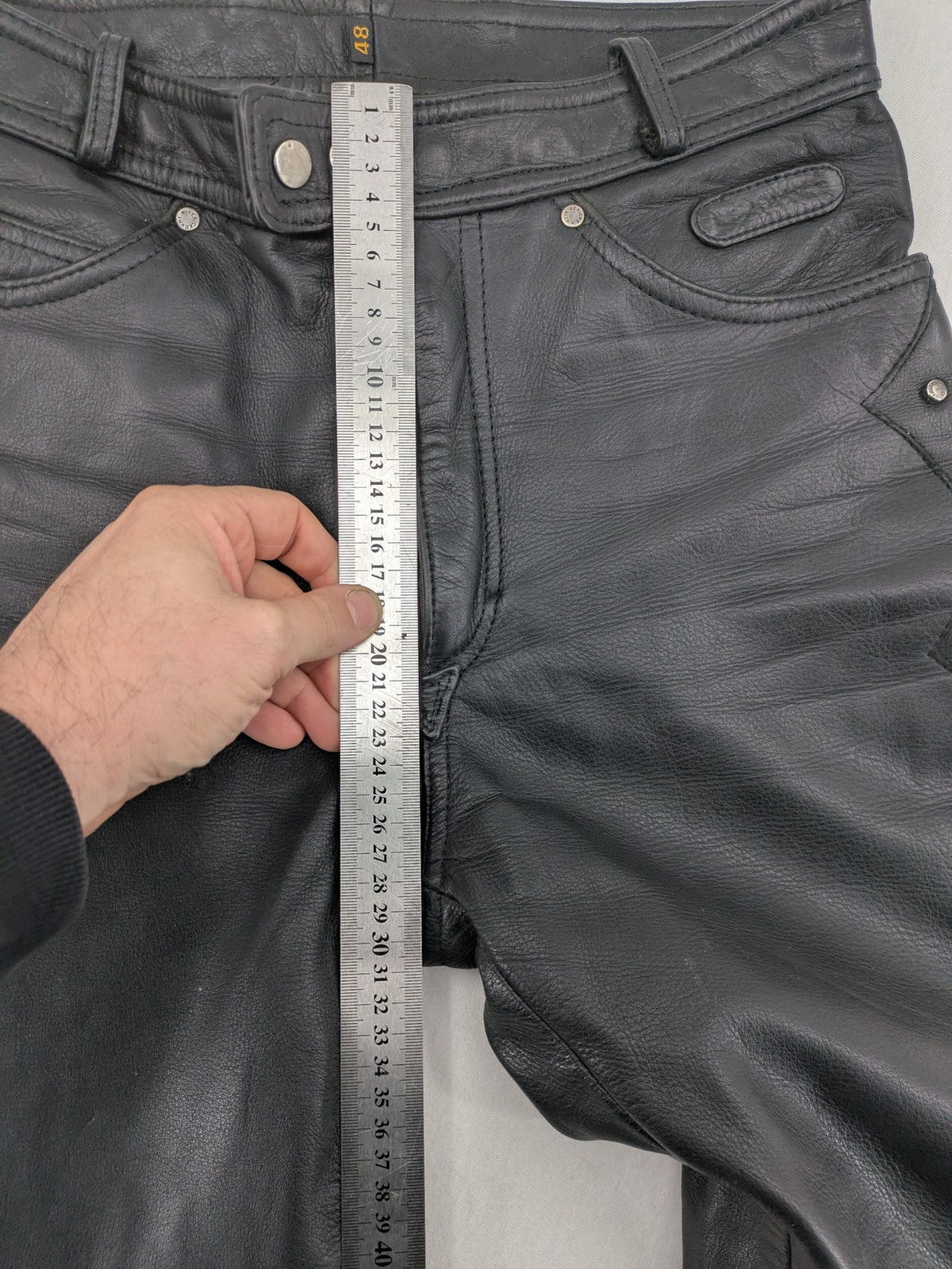 Hein Gericke black leather chaps with studs and wavy decorative seams.