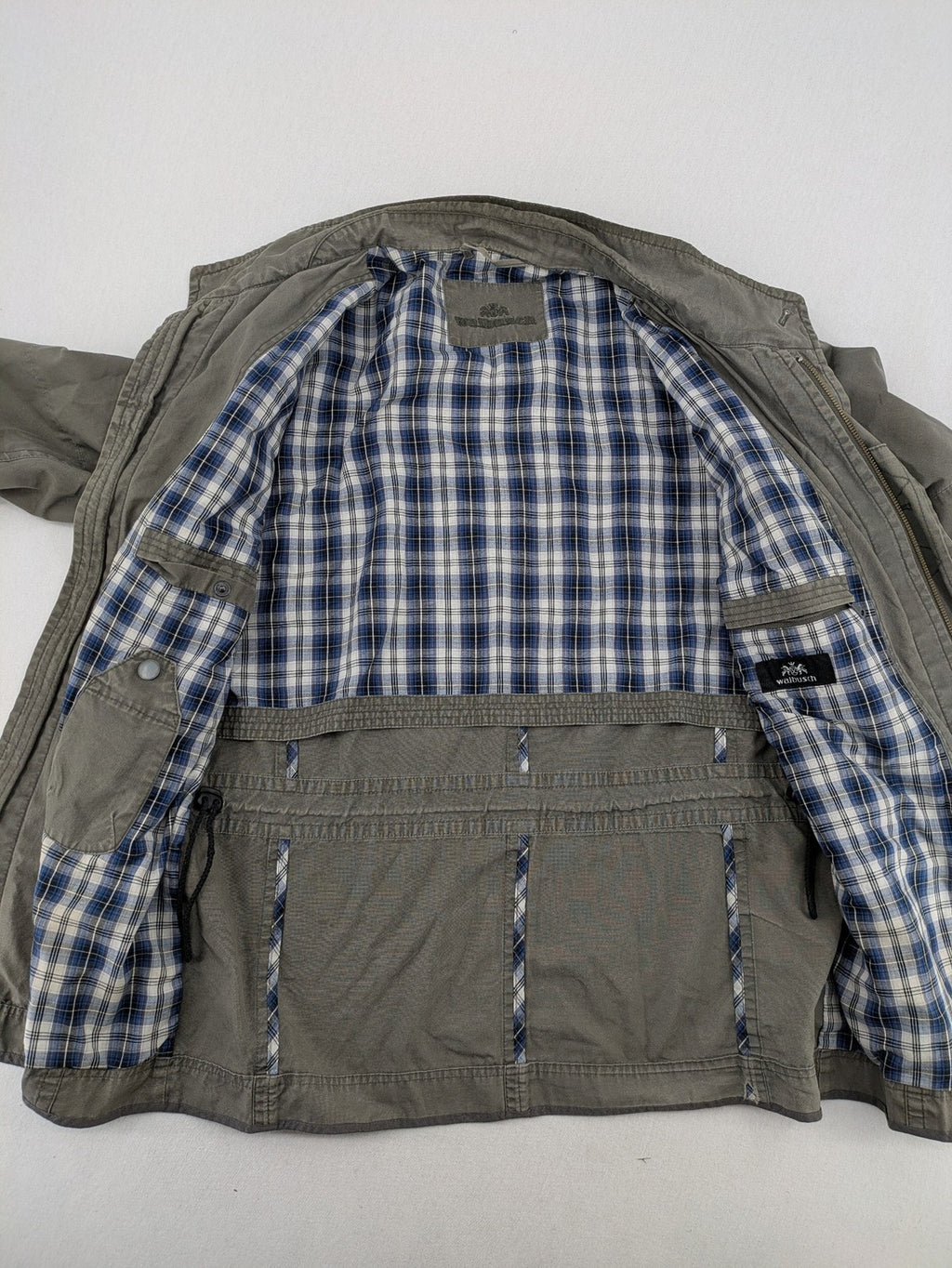 Walbusch khaki military jacket with checkered blue-white lining and multiple pockets.