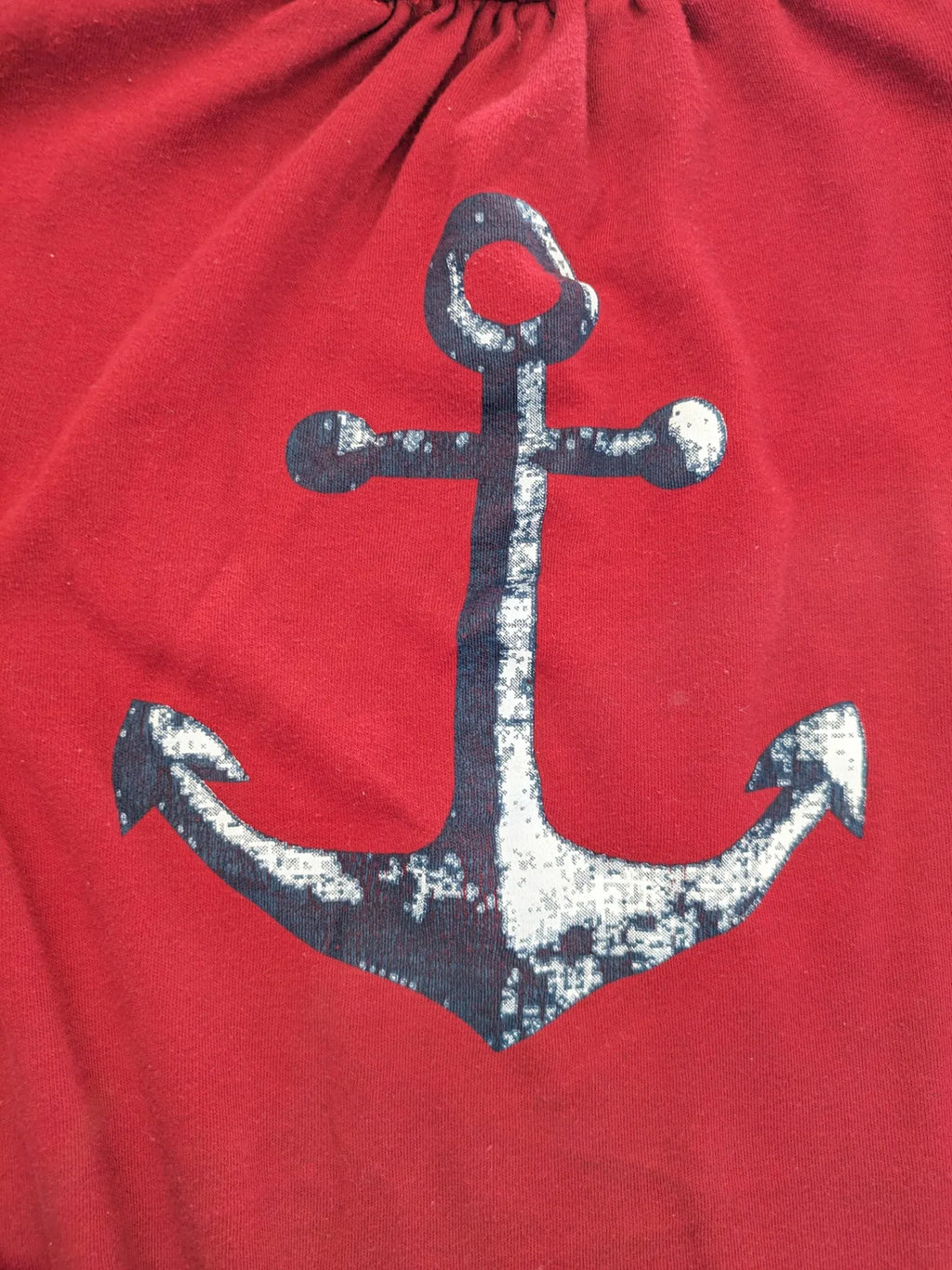 Normann red turtle neck jumper with large anchor print and side pockets.
