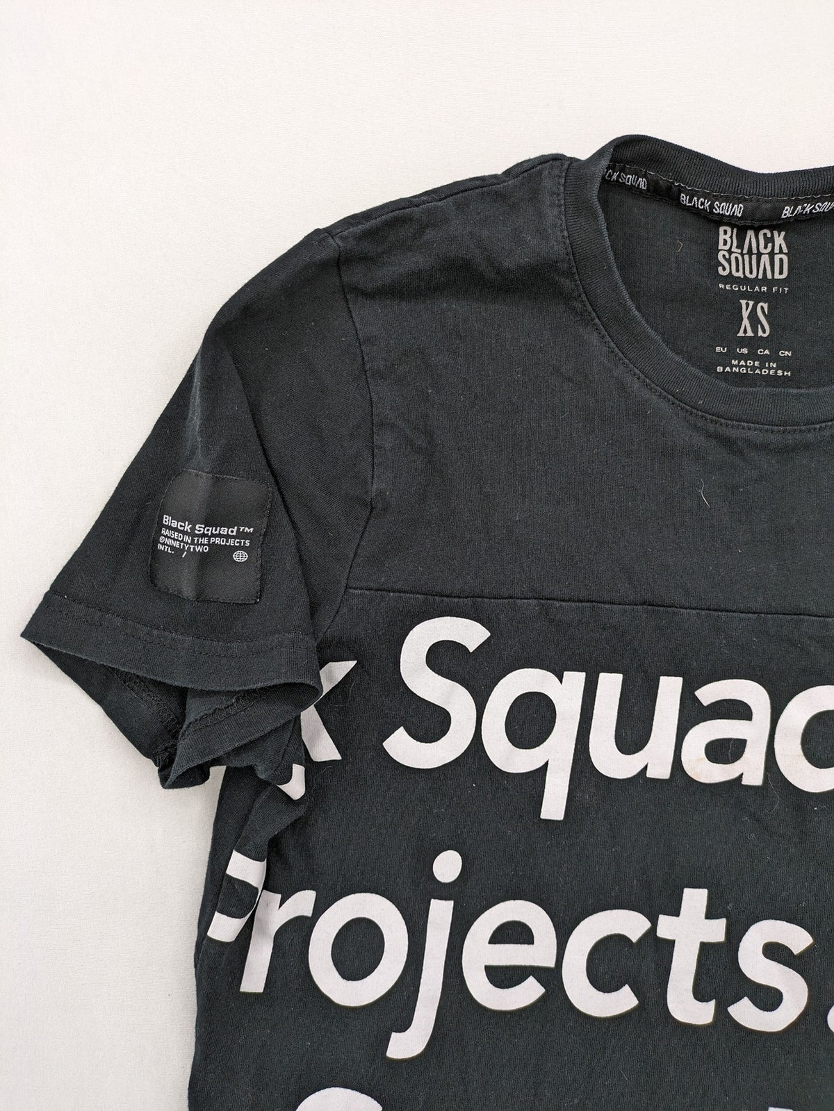 Black Squad black t-shirt all-over graphic print with logo patch on sleeve.