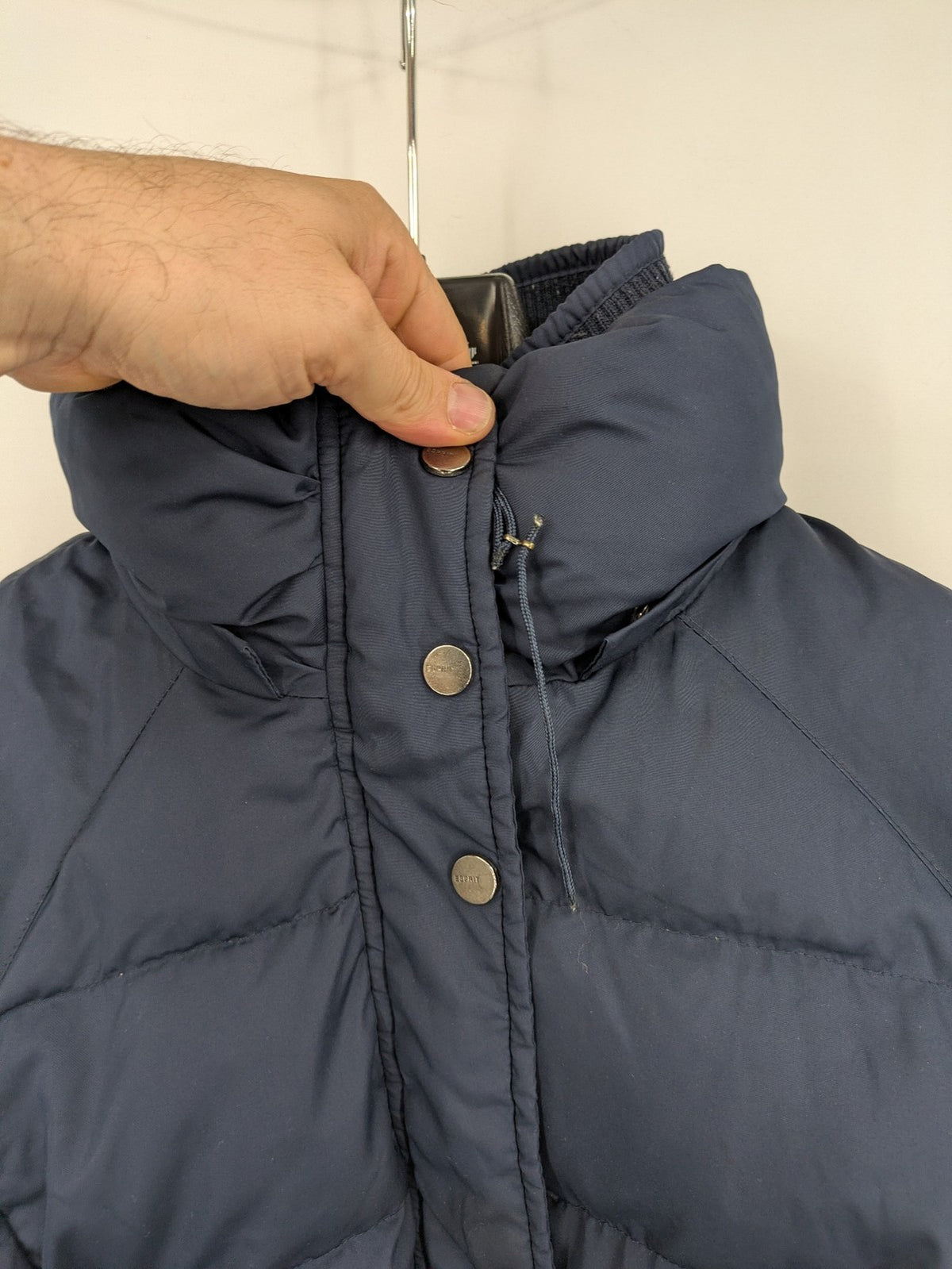 Esprit navy puffer jacket with belt, high collar, ribbed inner lining, and button placket.