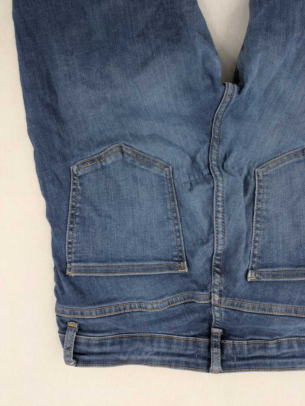 H&M blue skinny jeans with distressed details and comfortable stretch denim material.