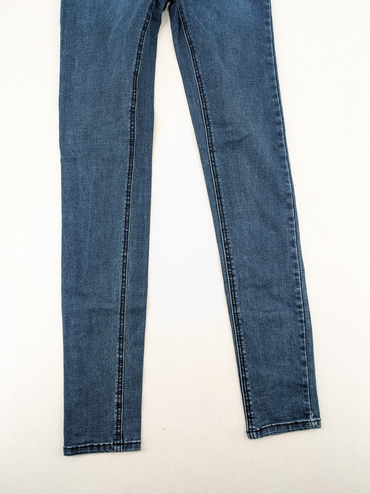 Dust blue skinny jeans with mid-rise waist and classic wash, stretch denim material.