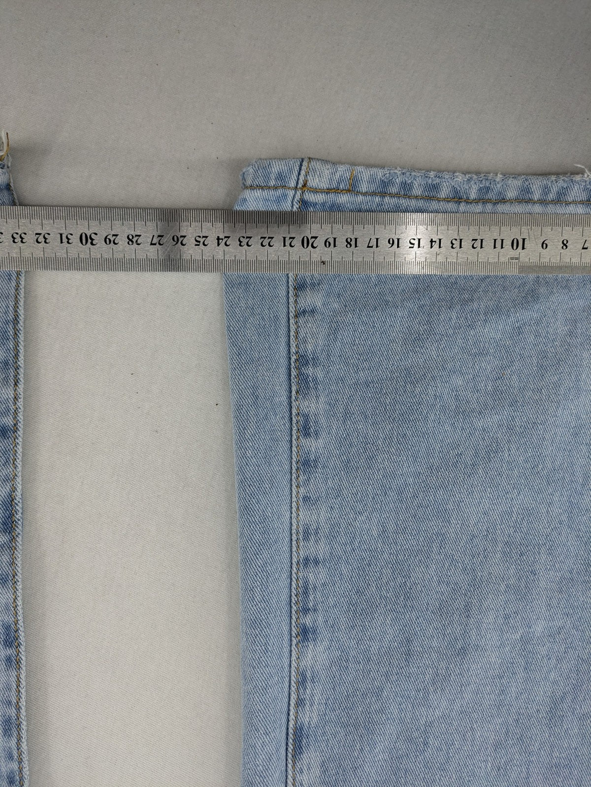Laulia blue wide leg jeans with distressed knee rips and high waist design.