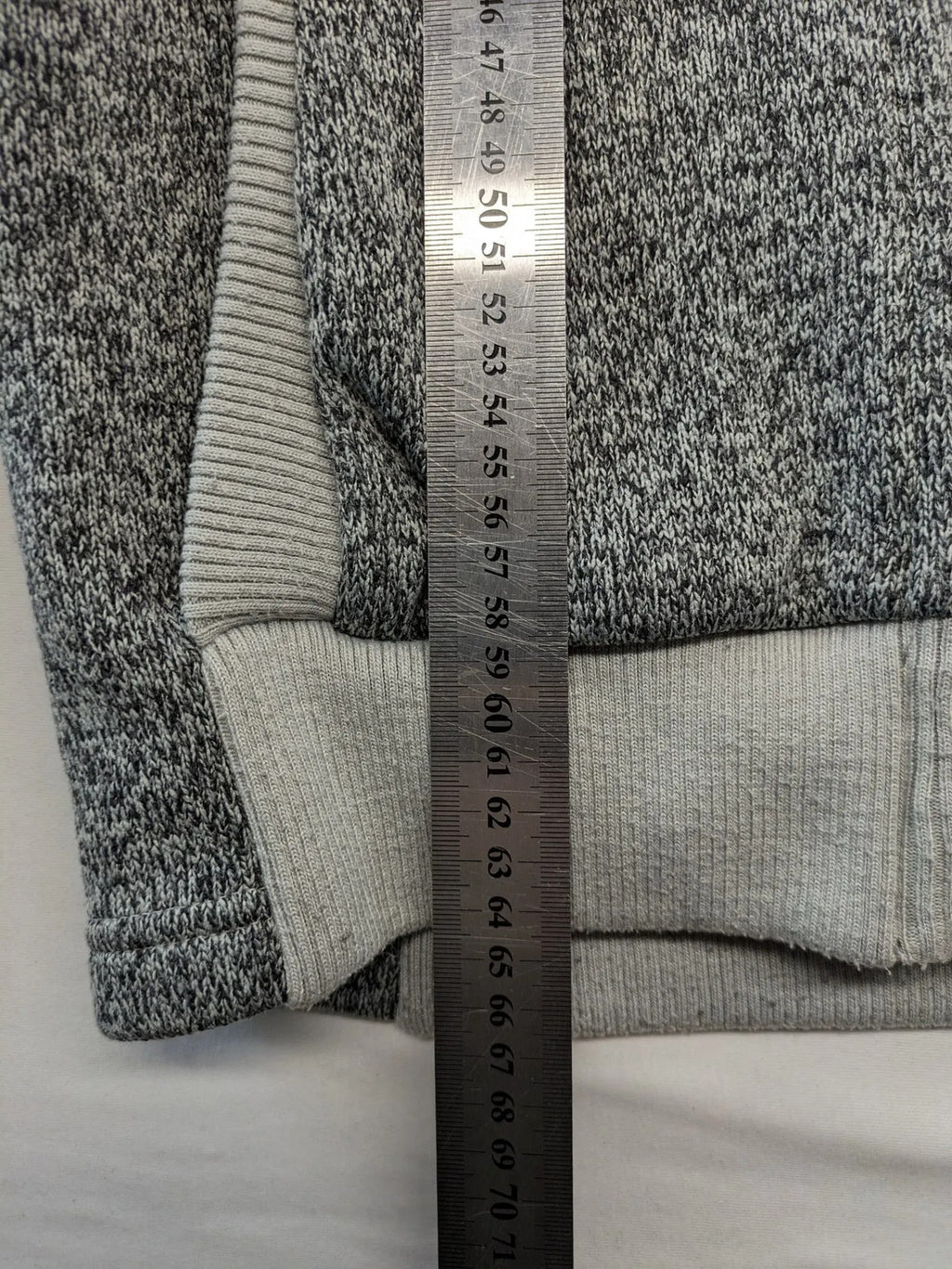 Jack Wolfskin grey fleece jacket with logo detailing and two front pockets.
