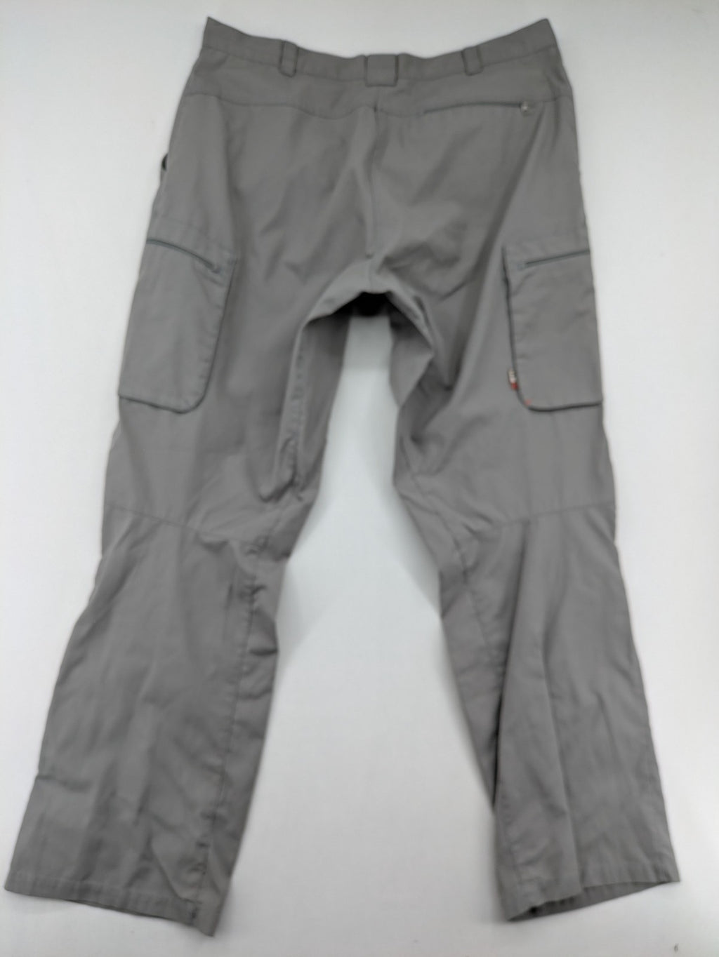 YETI grey cargo pants with multiple zippered pockets and durable material.