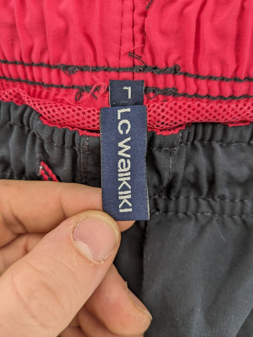 LC Waikiki navy swim shorts with red accents, elastic waistband, and quick-dry material.