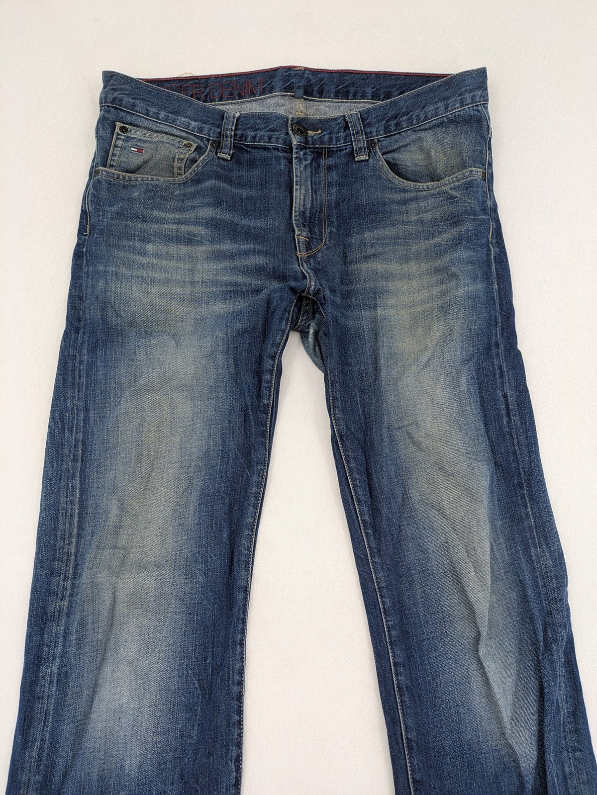 Hilfiger Denim blue straight jeans faded wash with Tommy Hilfiger flag logo on pocket.