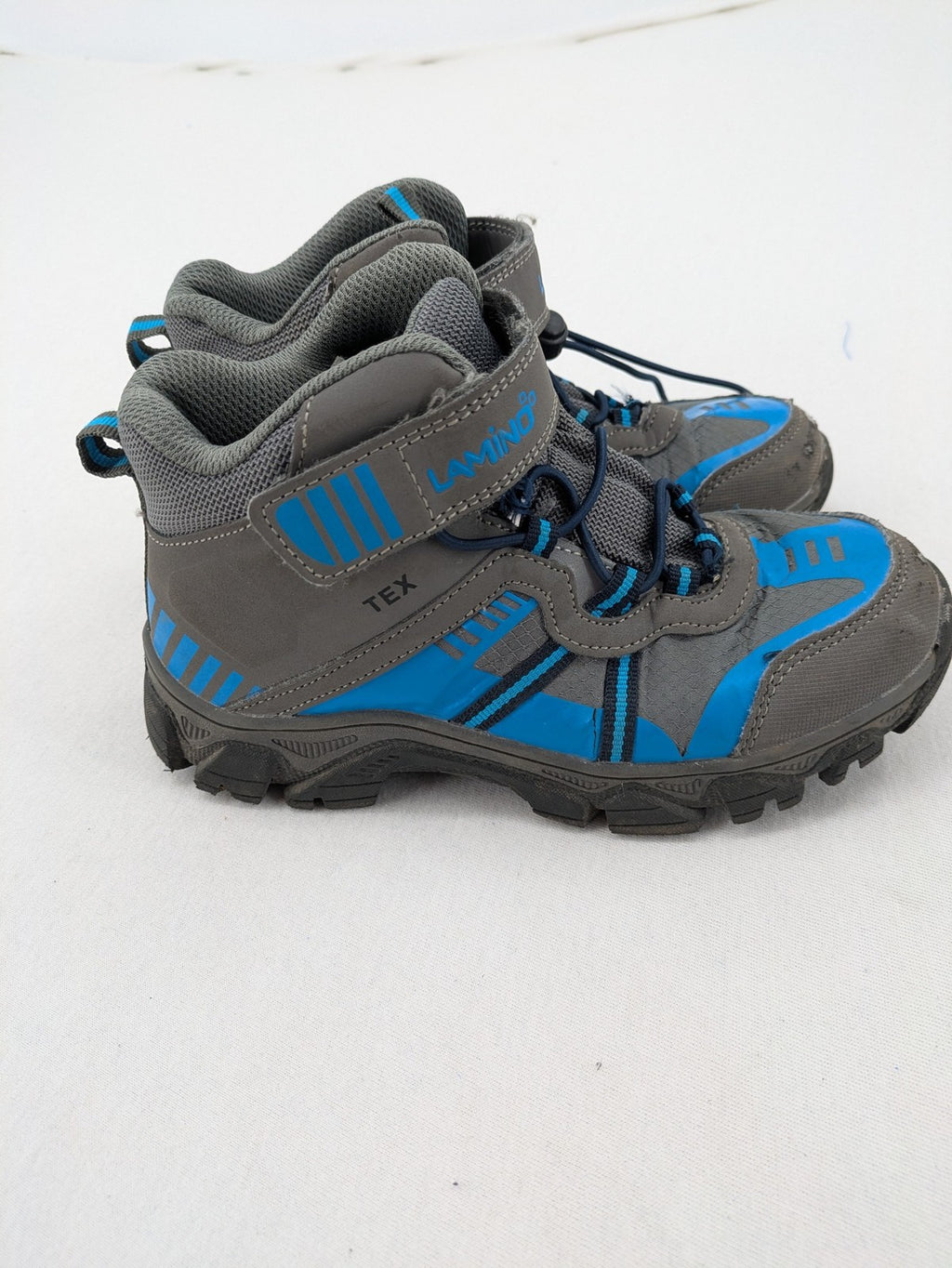 Outdoor grey and blue winter boots with high shaft, Velcro closure, and textured sole.