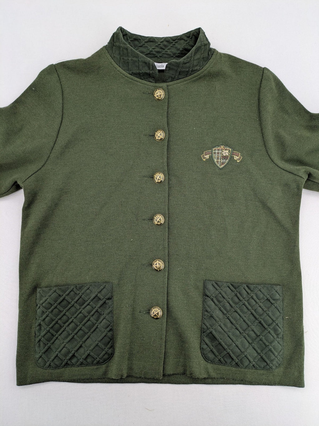LUCIA green Trachtenjacke with embroidered crest, quilted collar, and decorative buttons.
