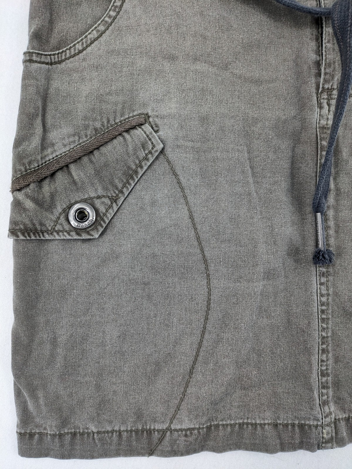 Bench khaki cargo mini skirt with belt, multiple pockets, and durable cotton material.