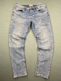 Jack & Jones blue slim fit jeans with button fly and light wash denim texture.