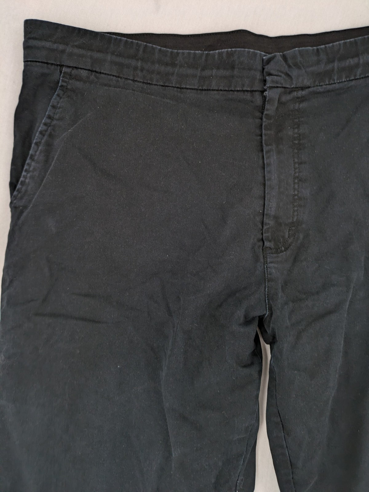 4F black cargo pants with reinforced knees, made from cotton-stretch material.