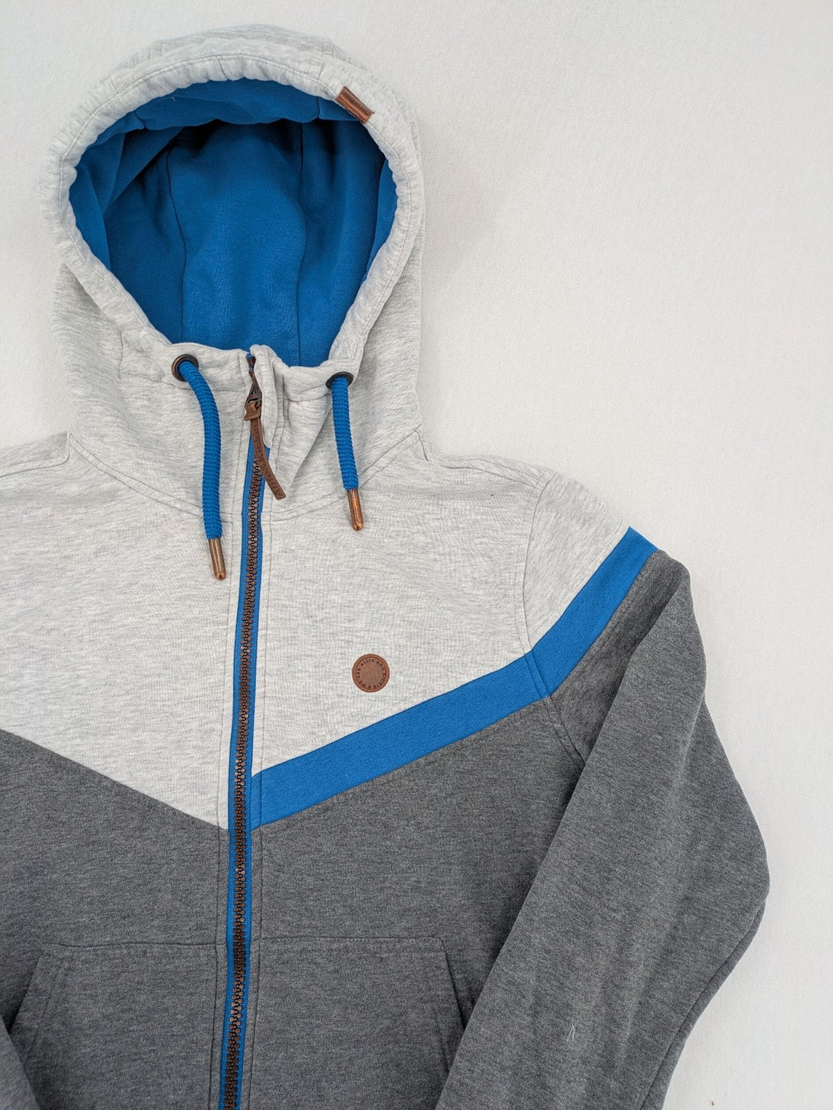ALIFE turtle neck jumper blue grey colorblock design with logo details and soft cotton blend.