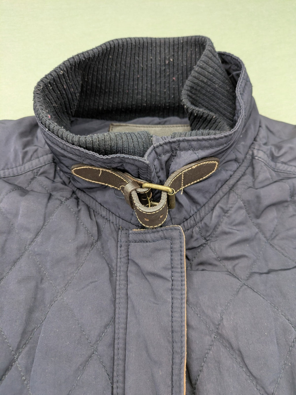 Massimo Dutti black quilted jacket with contrasting brown trim and ribbed side inserts.