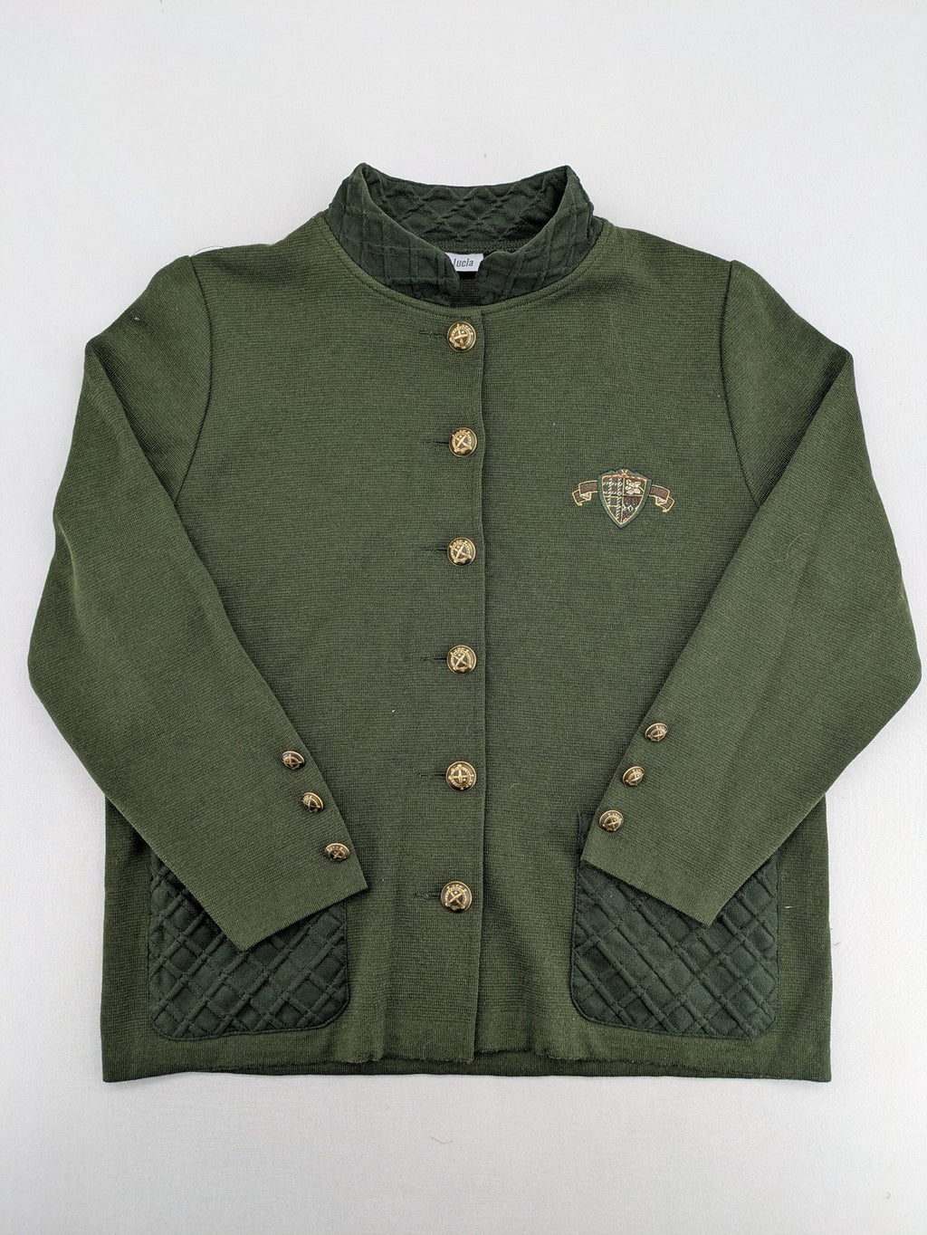 LUCIA green Trachtenjacke with embroidered crest, quilted collar, and decorative buttons.