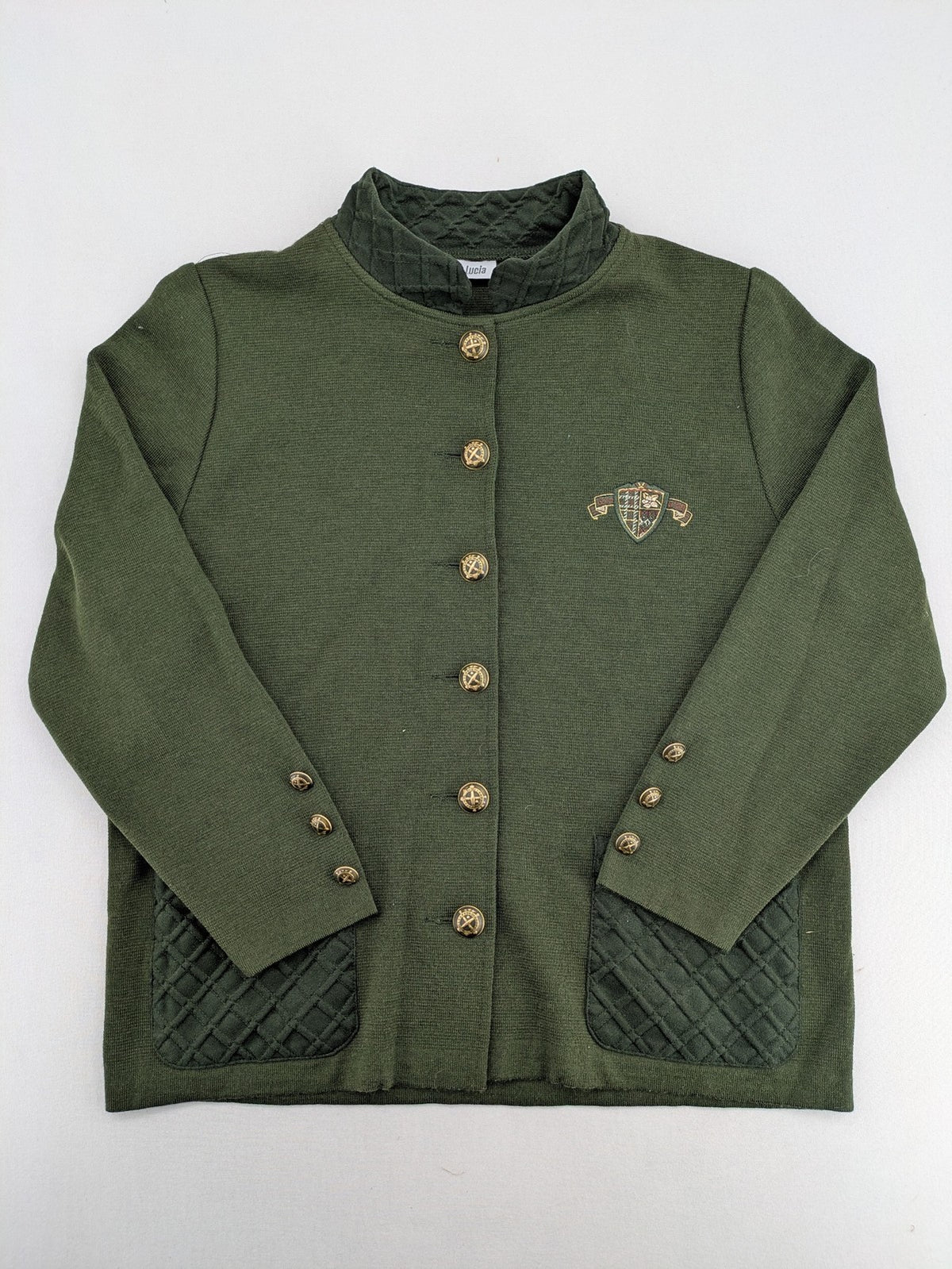 LUCIA green Trachtenjacke with embroidered crest, quilted collar, and decorative buttons.