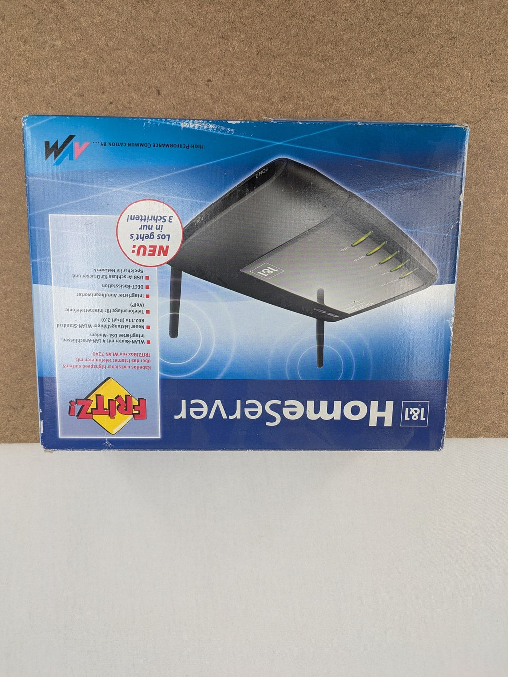 AVM black wireless router with integrated DSL modem and 1&1 logo.